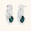 Organic-shaped stud earrings with hammered silver finish and green malachite-pattern resin stones on white background.
